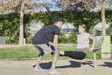 Woman during work out with coach in park - JNDF00179