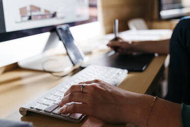 Female architect using computer at home - JRFF04523