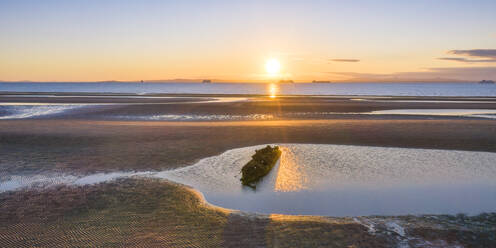 UK, Scotland, Wreck of X-Craft submarine lying on shore of Aberlady Bay at sunset - SMAF01887