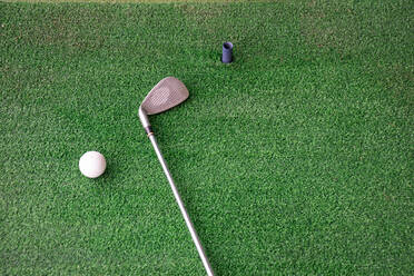 High Angle View Of Golf Ball And Iron On Driving Range - EYF07289