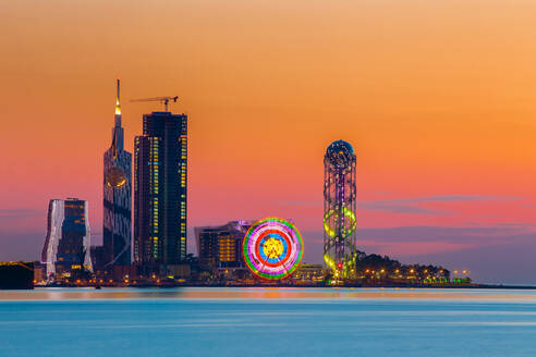 Illuminated City By River Against Sky During Sunset - EYF07301