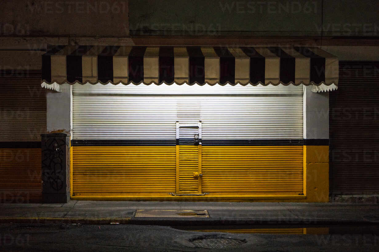 Closed Shutter Of Store At Night stock photo