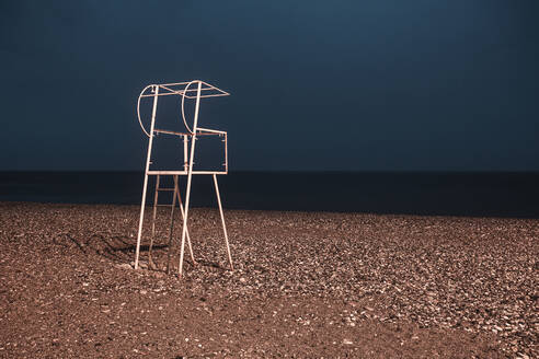 Georgia, Adjara, Batumi, Lifeguard chair on empty beach at night - WVF01801
