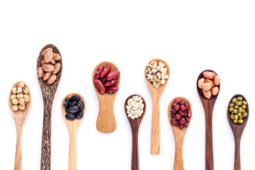 High Angle View Of Various Beans In Wooden Spoons On White Background - EYF07435