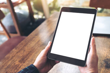 Cropped Hands Of Woman Using Blank Digital Tablet At Table In Cafe - EYF07576