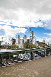 Germany, Frankfurt, Downtown skyscrapers seen from bridge on Main river - FLMF00260