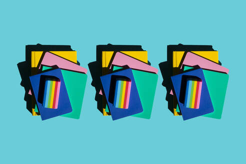 Row of stacks of notebooks and rainbow colored erasers - XLGF00268