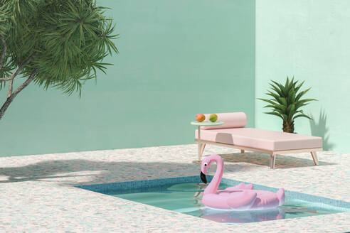 Pink toy flamingo floating on swimmingpool next to sunbed and palm trees - ECF01973