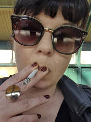 Smoking girl with sunglasses, Berlin, Germany - NGF00547