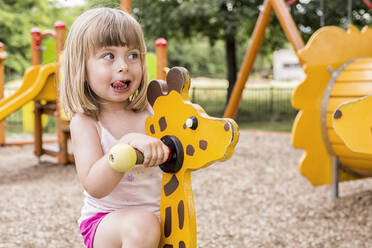 Portrait Of Cute Girl Playing At Playground - EYF07699