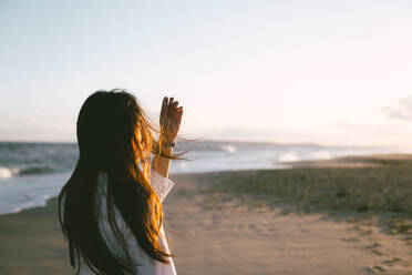 Young Woman Standing At Beach Against Sky - EYF07765