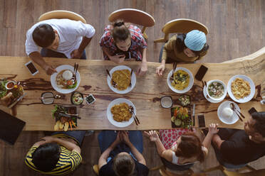 Directly Above Shot Of Friends Having Food On Restaurant Table - EYF07781