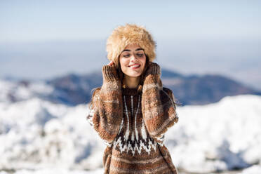 Young Woman With Eyes Closed Standing Outdoors During Winter - EYF07822