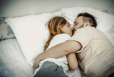 High Angle View of Couple Sleeping On Bed At Home - EYF07903