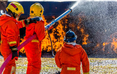 Firefighters Spraying Water On Fire - EYF07952