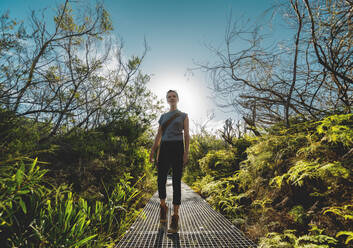 Woman Standing By Tree Against Sky - EYF07968