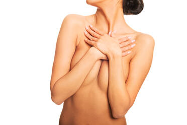 Midsection of Naked Woman Covering Breast While Standing Over White Background - EYF08008