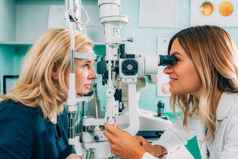 Optometrist Examining Patient At Clinic stock photo