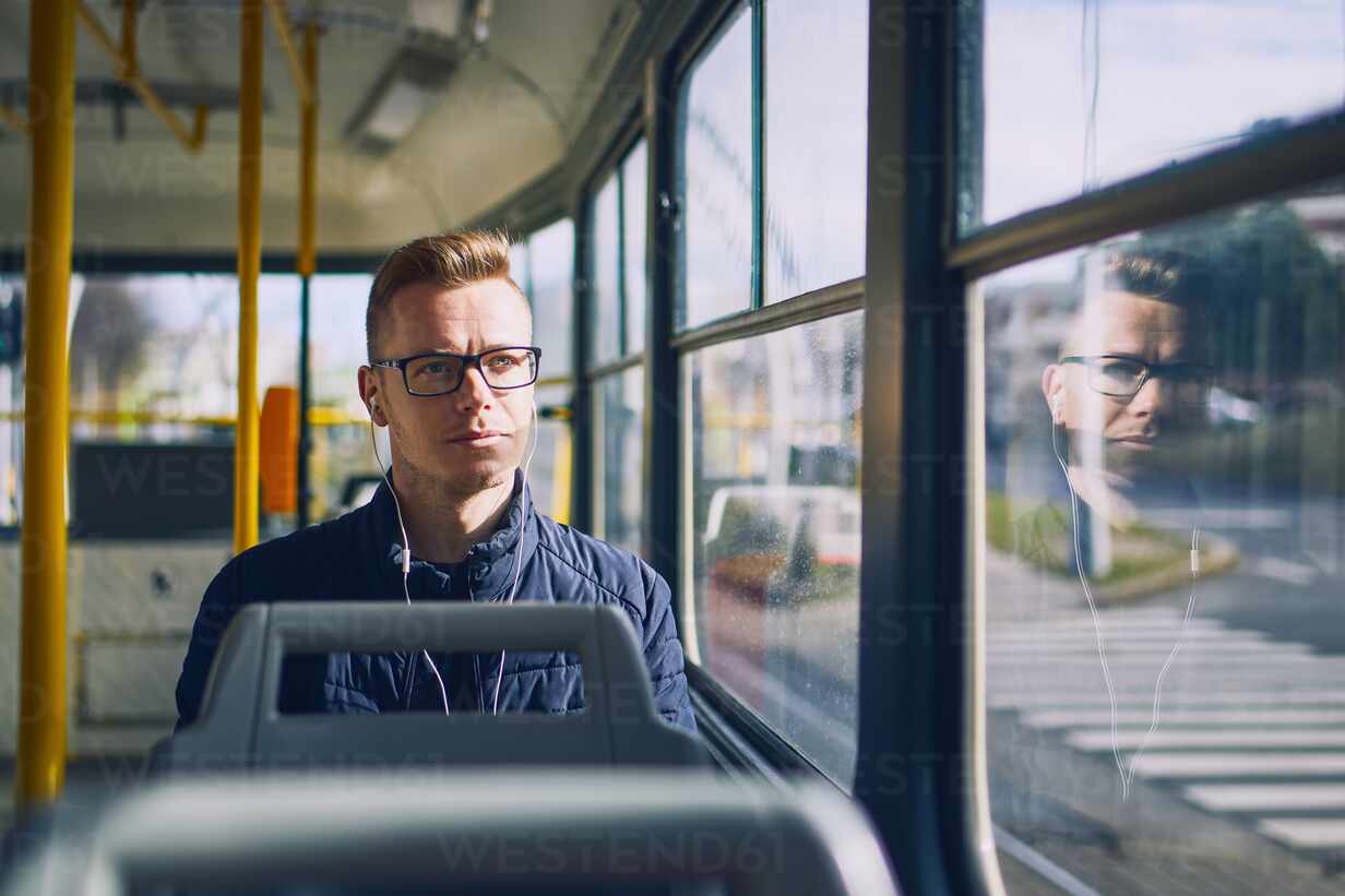 A Man is Sitting on the Bus Near a Glass Window with Steam Stock