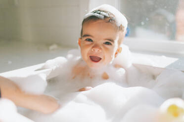 Cute Happy Baby Boy Taking Bubble Bath In Kitchen Sink At Home - EYF08207
