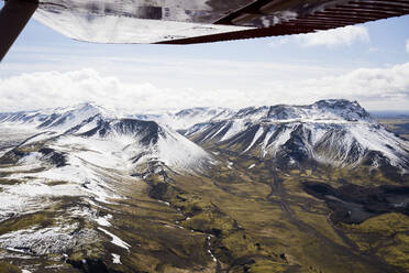 Aerial view of icelandic mountains from airplane wing pov - CAVF85744