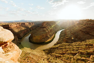 Sun shines over a big bend in the green river canyon in canyonlands - CAVF85826