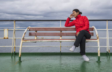 Woman relaxing on a passenger vessel traveling in South America - CAVF86105