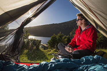 Man camping at the Chilean lake district, Pucon, Chile - CAVF86116