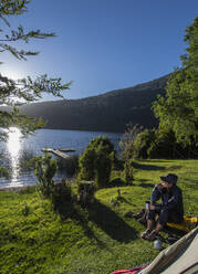 Woman camping at the Chilean lake district, Pucon, Chile - CAVF86119