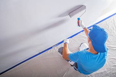 High Angle View Of Worker Painting On Wall At Home - EYF08300
