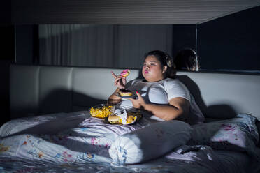 Fat Woman Eating Food On Bed At Home - EYF08332