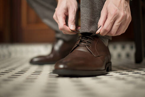 Low Section Of Man Tying Shoelace At Home - EYF08589