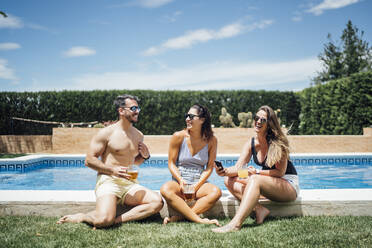 Friends during pool party toasting with beer - OCMF01371