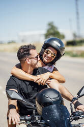 Couple sitting on motorbike - OCMF01384