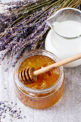 High Angle View Of Honey With Milk On Table - EYF08674