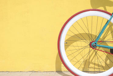 Nahaufnahme von Fahrrad geparkt durch gelbe Wand - EYF08742