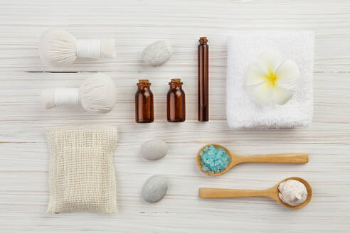 Directly Above Shot Of Spa Equipment Arranged On Wooden Table - EYF08781