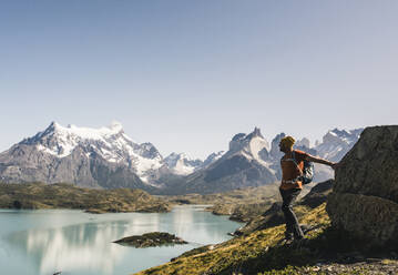 Man standing by lake against clear sky, Torres Del Paine National Park, Patagonia, Chile - UUF20745