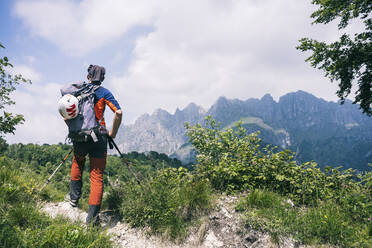Hiker standing on mountain path enjoying view, Orobie, European Alps, Como, Italy - MCVF00474