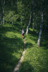 Hiker walking on mountain path, Orobie, European Alps, Como, Italy - MCVF00476