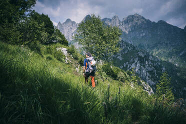 Hiker walking on mountain path, Orobie, European Alps, Como, Italy - MCVF00477