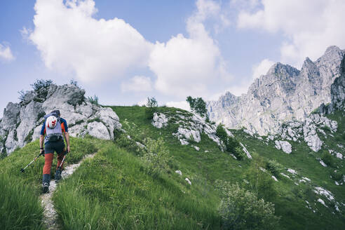 Hiker walking on mountain path, Orobie, European Alps, Como, Italy - MCVF00479