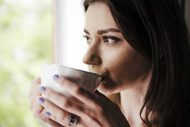 Close-up Of woman drinking coffee - EBBF00289