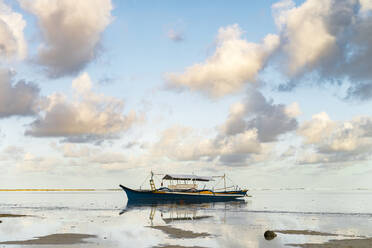 Philippines, Siargao, General Luna, Fishing boat on sea at sunset - JMPF00006