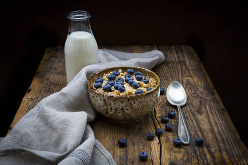 Milk bottle and bowl of granola with blueberries and quinoa - LVF08947