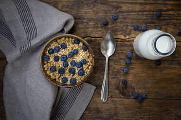 Milk bottle and bowl of granola with blueberries and quinoa - LVF08948