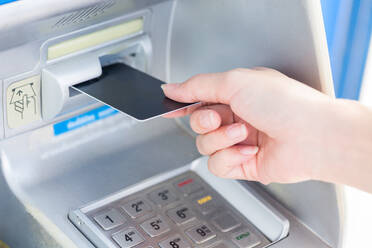 Cropped Hand Of Woman Using Atm - EYF08882