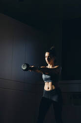 Woman doing dumbell training at home - OCAF00540