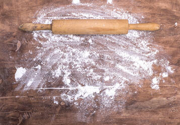 Directly Above Shot Of Rolling Pin With Flour On Wooden Table - EYF08971