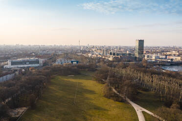 Germany, Berlin, Aerial view of Treptower Park in autumn with city buildings in background - TAMF02427